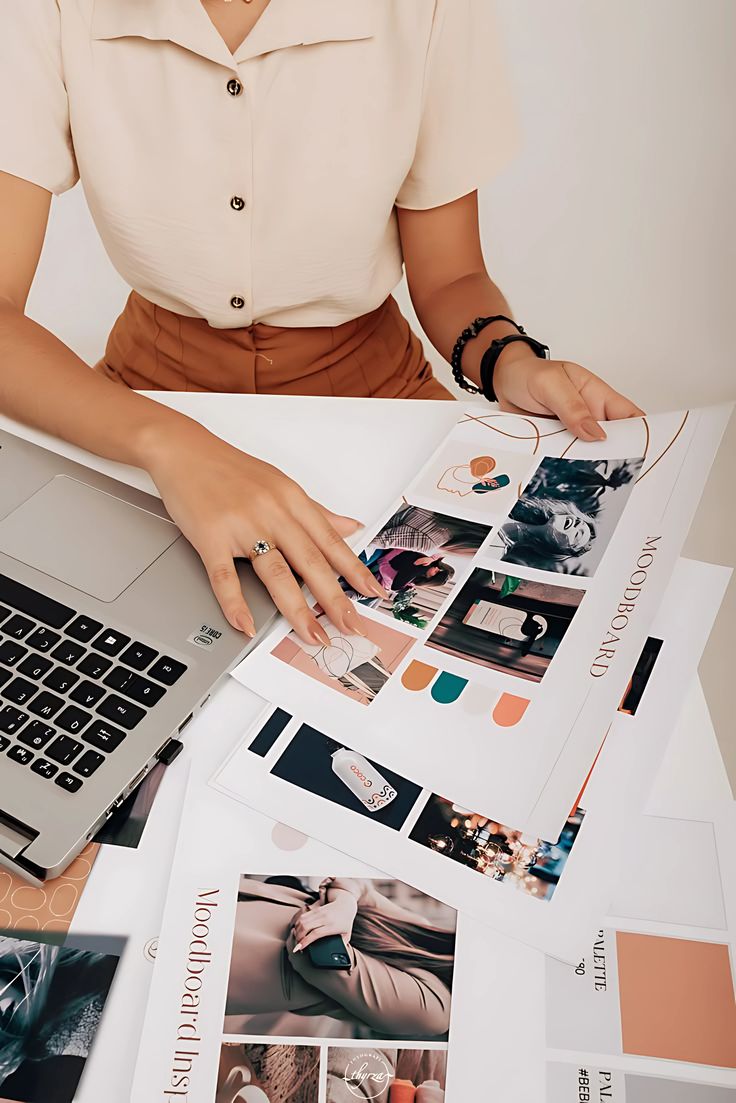 Moodboards and palettes spread across a designer’s desk