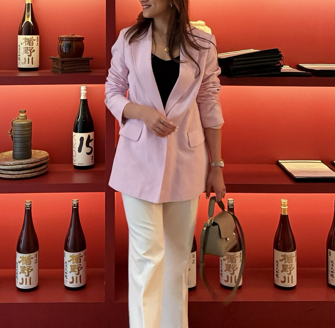 Shreya Gulati in a lilac blazer against a deep red backdrop
